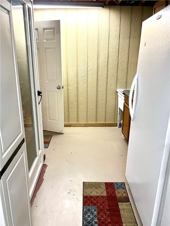 basement with white fridge