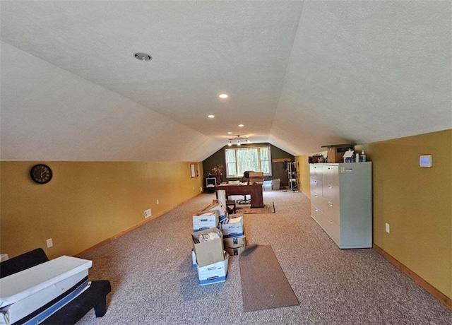 bonus room featuring lofted ceiling, a textured ceiling, and light carpet