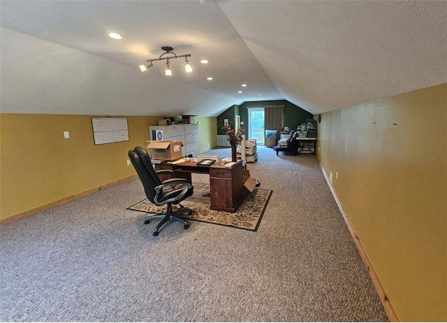 office area featuring carpet, a textured ceiling, and vaulted ceiling