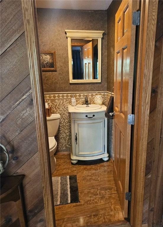 bathroom with vanity, hardwood / wood-style flooring, and toilet