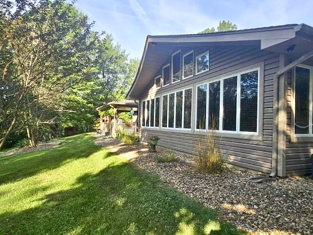 view of side of home with a yard