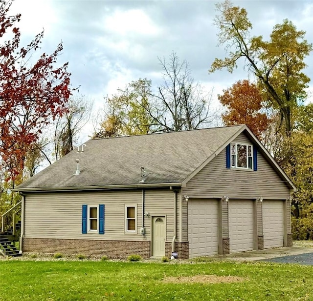 view of front of property with a front yard and a garage