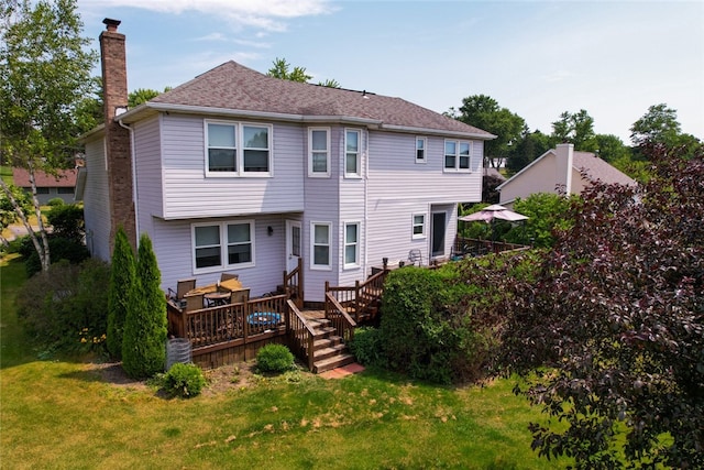 back of house with a deck, a lawn, and central air condition unit