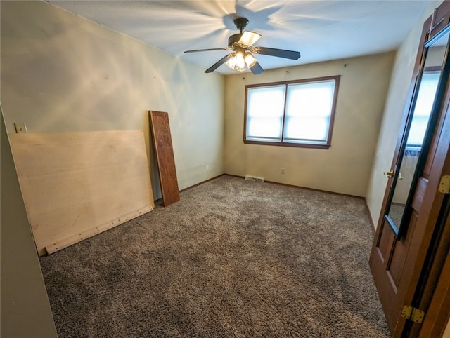 carpeted spare room featuring ceiling fan