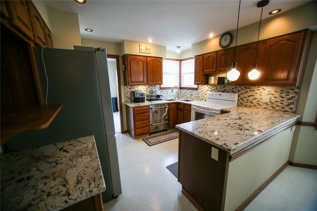 kitchen featuring white range with electric stovetop, kitchen peninsula, hanging light fixtures, tasteful backsplash, and light stone countertops