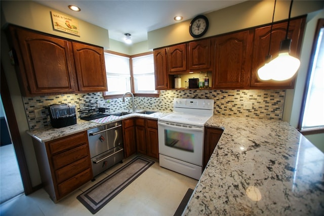 kitchen featuring sink, white electric stove, light tile floors, and backsplash