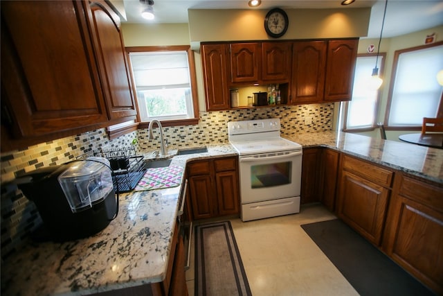 kitchen featuring decorative light fixtures, white range with electric cooktop, tasteful backsplash, and light tile flooring