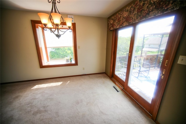 interior space with a notable chandelier and carpet floors