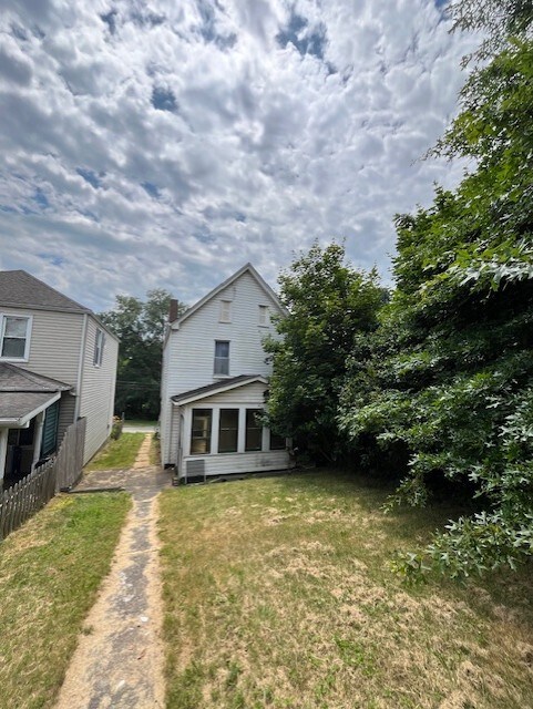 rear view of house with a yard