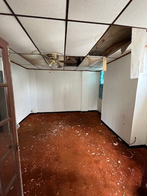 613 Center St, Versailles Boro, PA 15132 - basement featuring a paneled ceiling and dark colored carpet