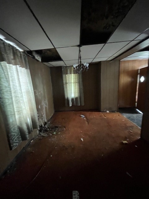 interior space featuring a notable chandelier and a paneled ceiling