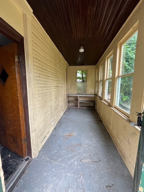 unfurnished sunroom featuring wood ceiling