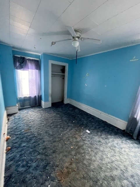 613 Center St, Versailles Boro, PA 15132 - unfurnished bedroom featuring baseboard heating, ceiling fan, and a closet
