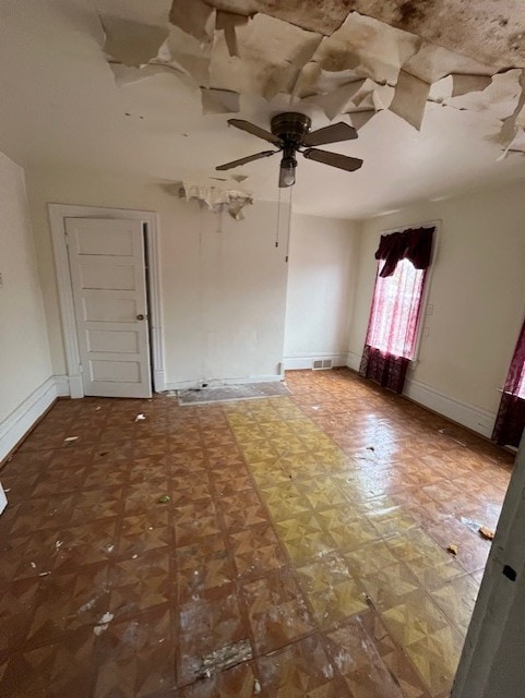 unfurnished bedroom featuring ceiling fan and parquet flooring