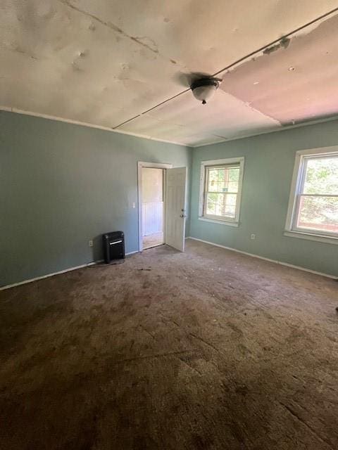 empty room featuring plenty of natural light and carpet flooring