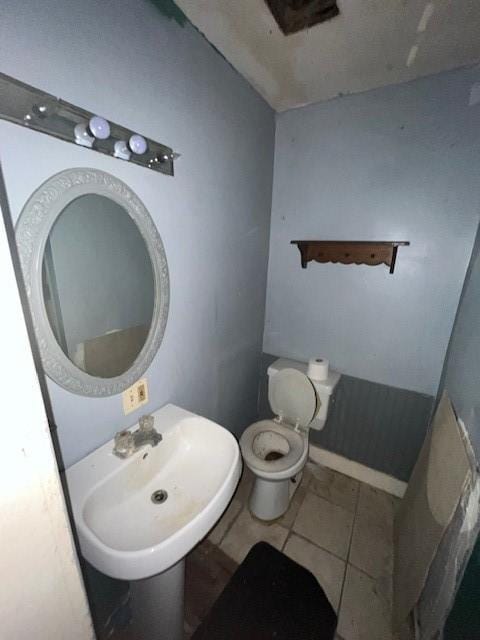 bathroom featuring tile patterned flooring, sink, and toilet