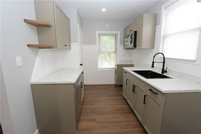 kitchen featuring light stone counters, gray cabinetry, sink, and dark hardwood / wood-style flooring