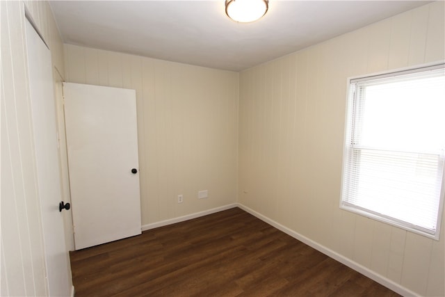 empty room featuring dark hardwood / wood-style flooring