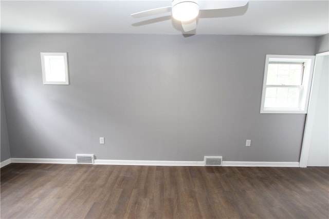 spare room featuring ceiling fan and dark hardwood / wood-style flooring