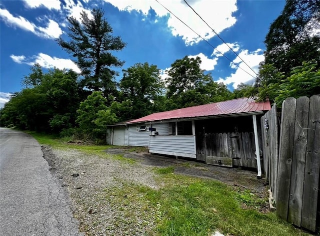 view of property exterior with an outdoor structure