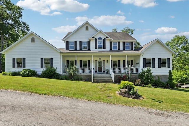 colonial-style house featuring a porch and a front lawn