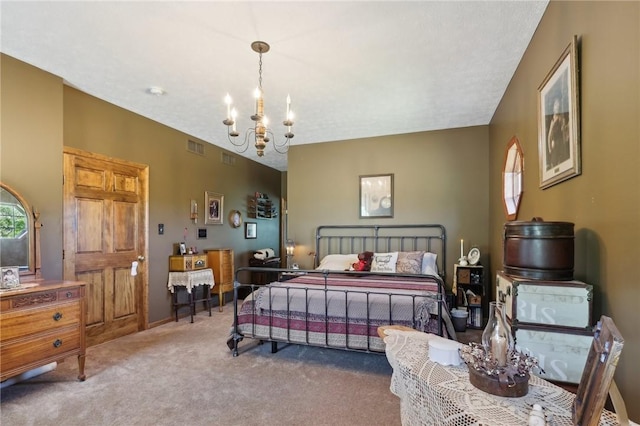 bedroom featuring carpet flooring and an inviting chandelier