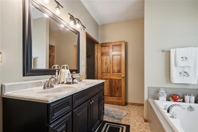 bathroom featuring vanity, tile patterned floors, and tiled tub