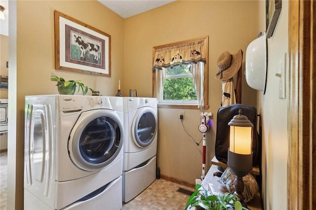 clothes washing area with washer and clothes dryer