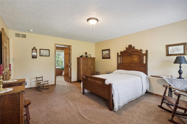 bedroom featuring light colored carpet and a textured ceiling