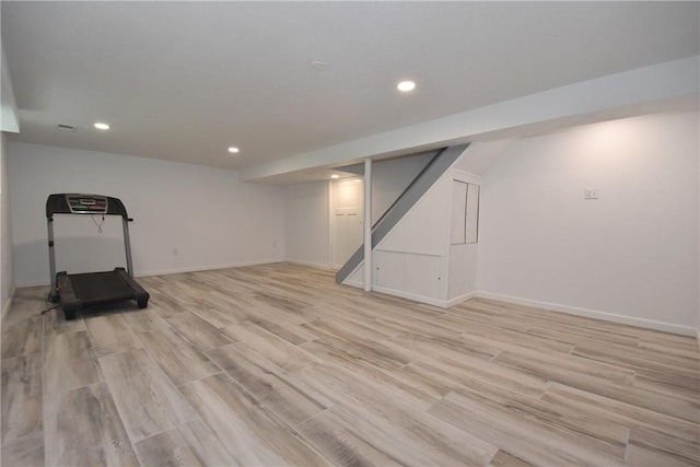 finished below grade area featuring baseboards, light wood finished floors, and recessed lighting