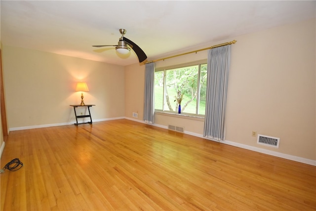 empty room featuring ceiling fan and light hardwood / wood-style flooring