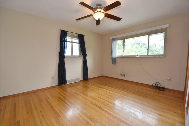 spare room featuring light wood-type flooring and ceiling fan