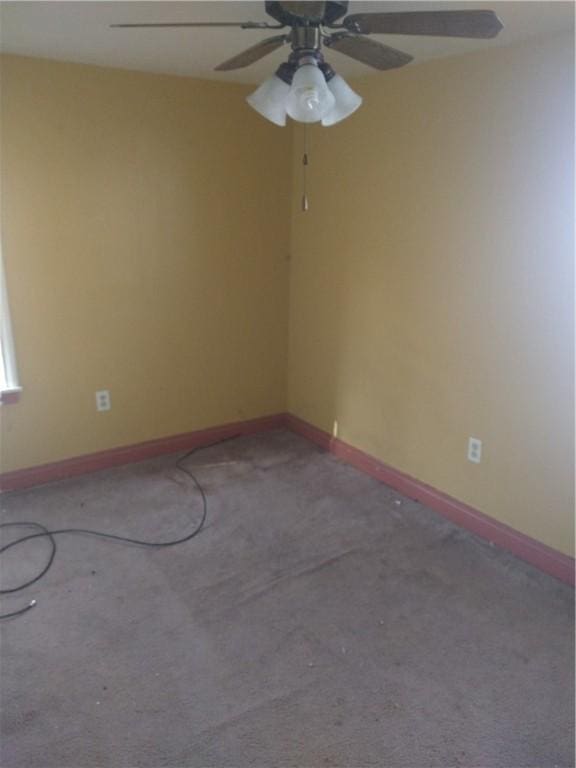 unfurnished room with baseboards