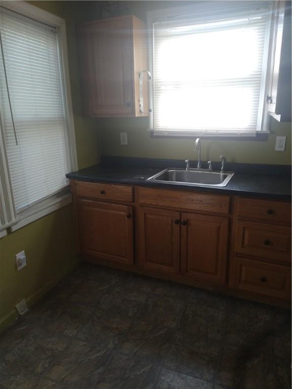 kitchen featuring sink and dark tile floors