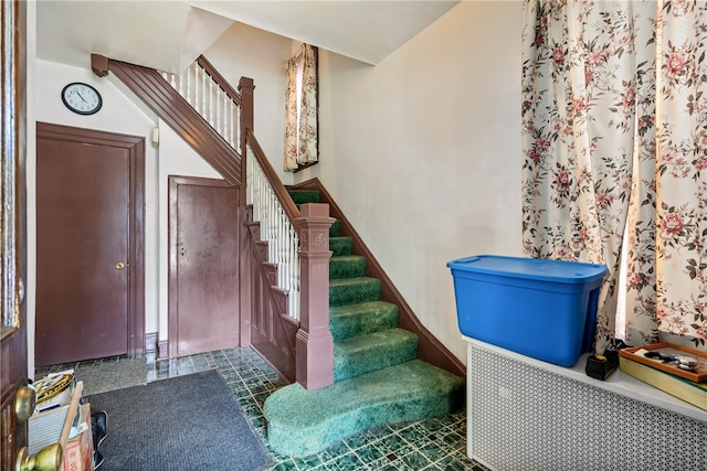 staircase featuring tile floors