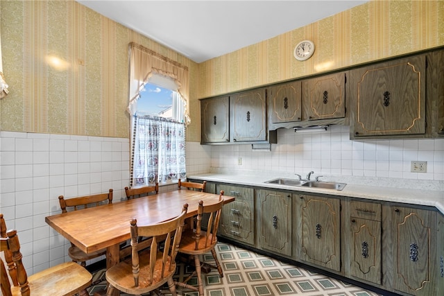 kitchen with backsplash, sink, and light tile floors