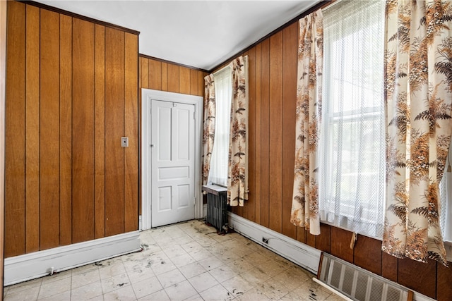 interior space with radiator heating unit and wood walls