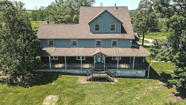 back of house with covered porch and a yard