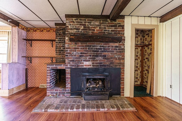 interior details with hardwood / wood-style flooring and a drop ceiling