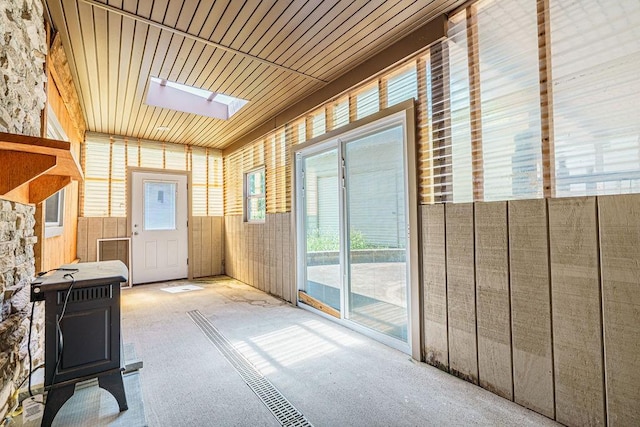 interior space with a skylight and wooden ceiling