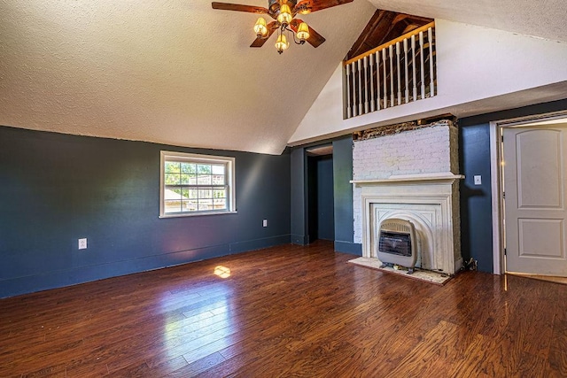 unfurnished living room featuring a textured ceiling, dark hardwood / wood-style floors, high vaulted ceiling, and ceiling fan