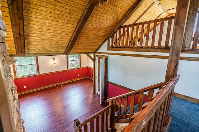 additional living space with vaulted ceiling with beams, dark hardwood / wood-style floors, and wooden ceiling