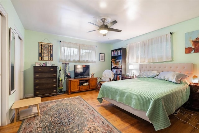 bedroom with ceiling fan and light wood-type flooring