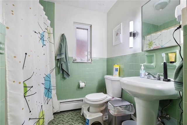 bathroom with a shower with shower curtain, toilet, tile walls, and a baseboard heating unit