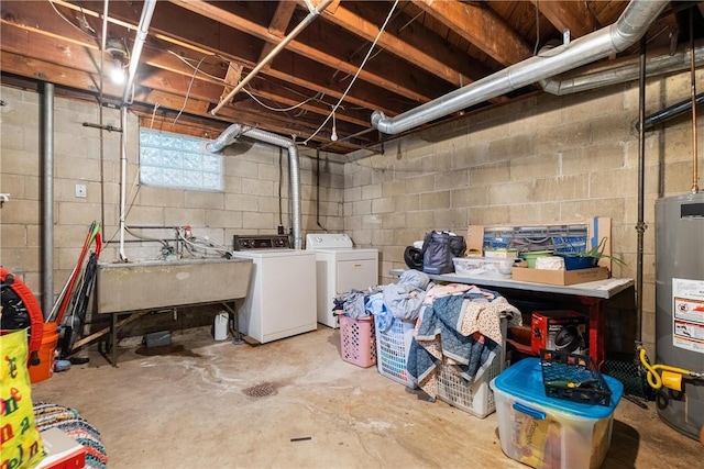 basement featuring washing machine and clothes dryer, sink, and water heater