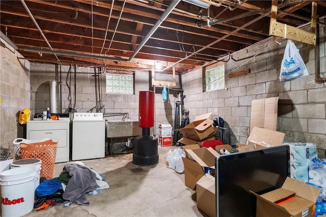 basement featuring washing machine and dryer and sink