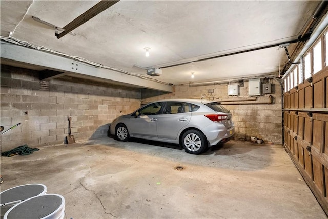 garage featuring electric panel and a garage door opener