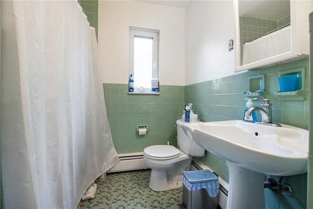 bathroom with baseboard heating, curtained shower, tile walls, and toilet