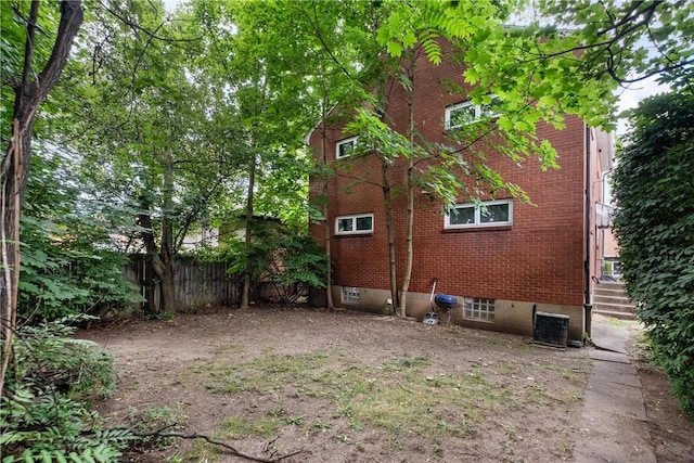 view of side of property featuring central air condition unit