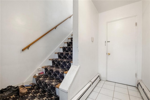 stairway featuring a baseboard radiator and tile patterned floors